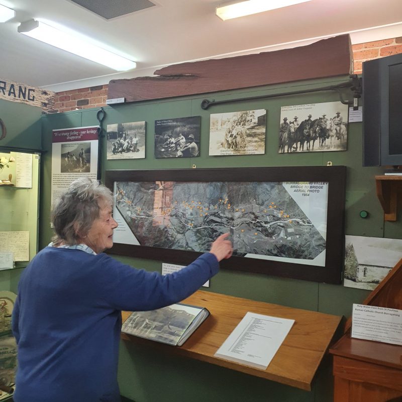 Doreen Lyons points out the location of the Oaks on the 1954 Burragorang Bridge to Bridge aerial photo